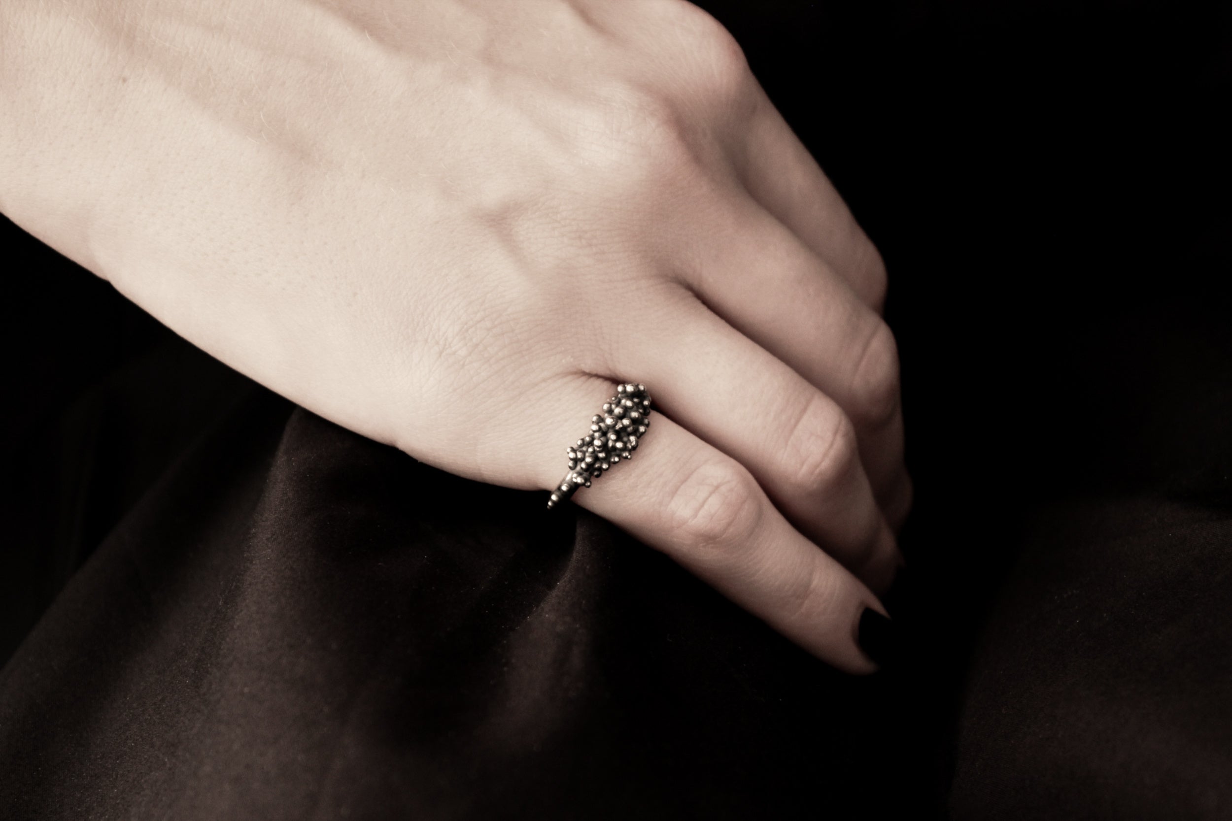 Handcrafted oxidised solid silver droplets ring number 3 on a model - Natt Jewellery
