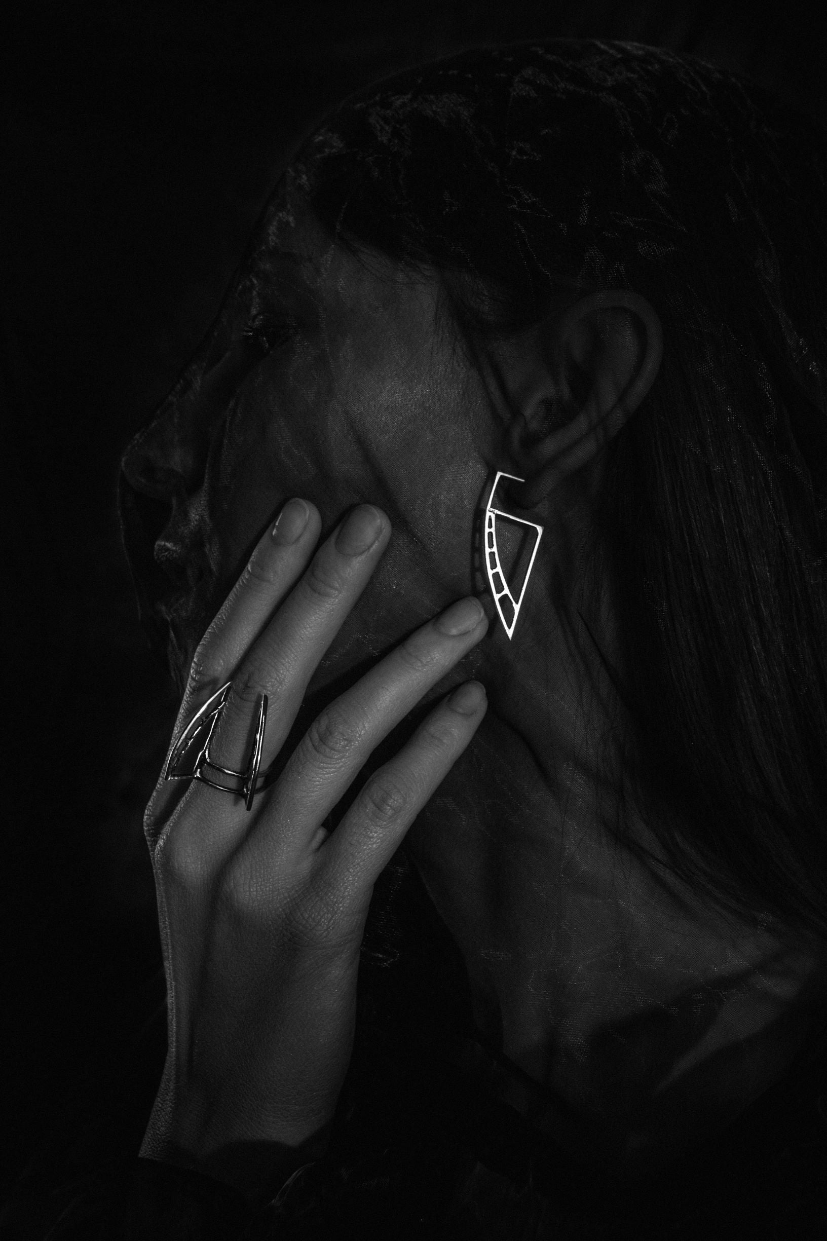 Handcrafted unique futuristic silver ring and earrings Astral Sails small on a model - Natt Jewellery