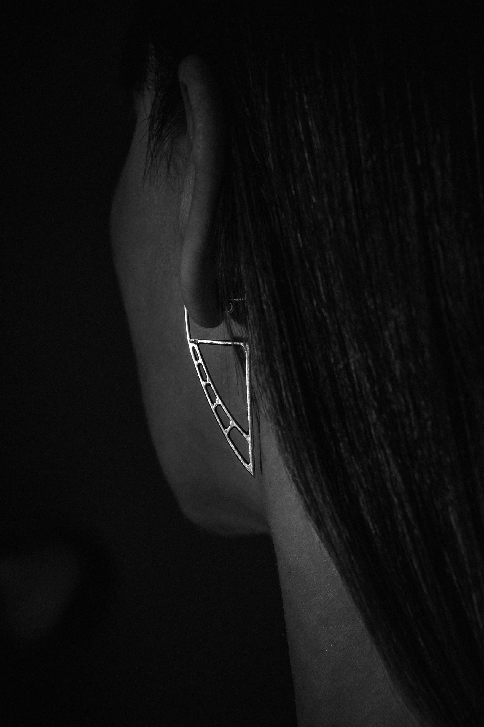 Unique handcrafted avant-garde silver earrings Astral Sails small on a model - Natt Jewellery